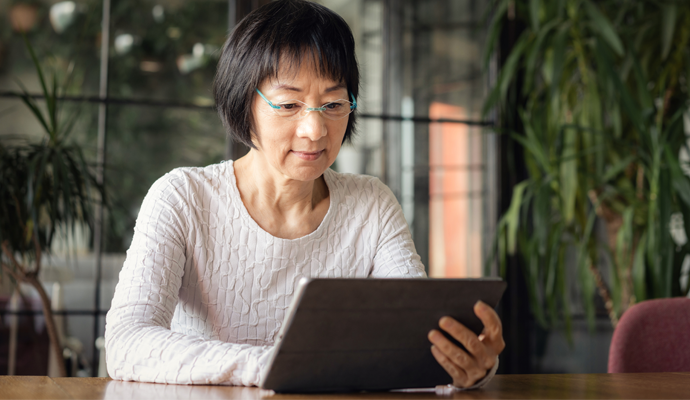 woman using tablet at table