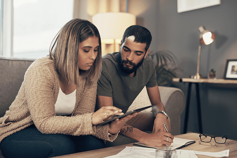 younger couple looking at tablet together