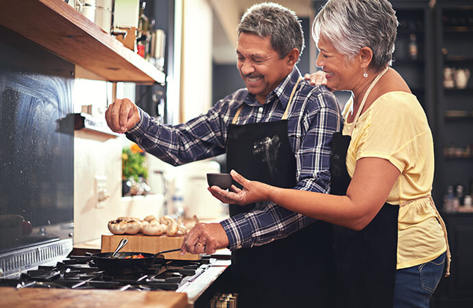 Mature couple cooking together