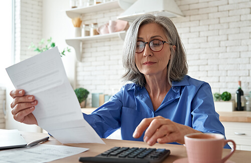 Mature woman with calculator