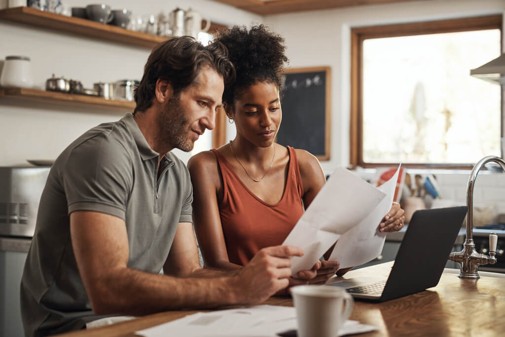 Couple with laptop and papers