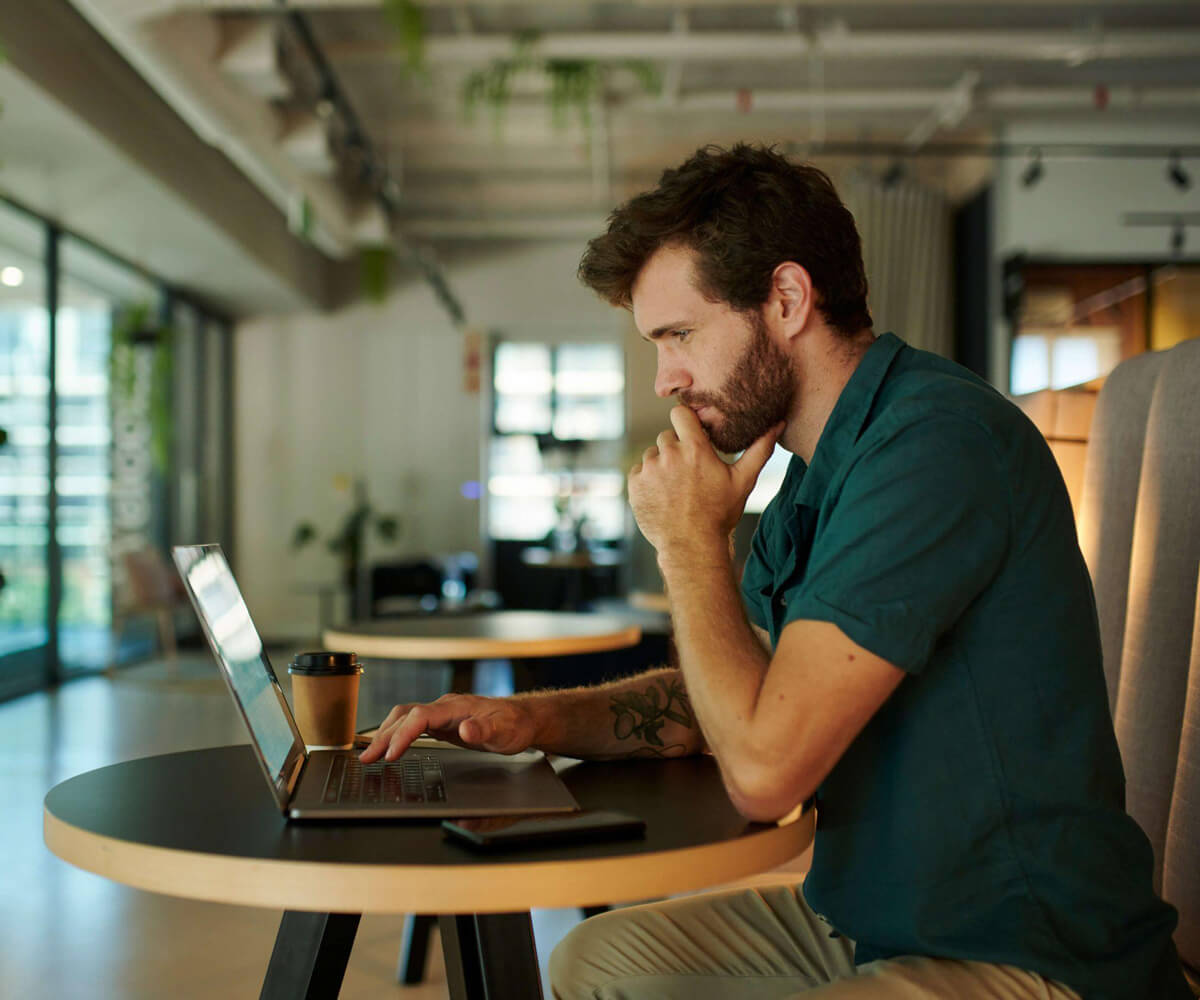 Man on laptop with coffee