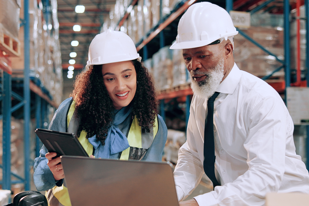 Warehouse workers on laptop and tablet