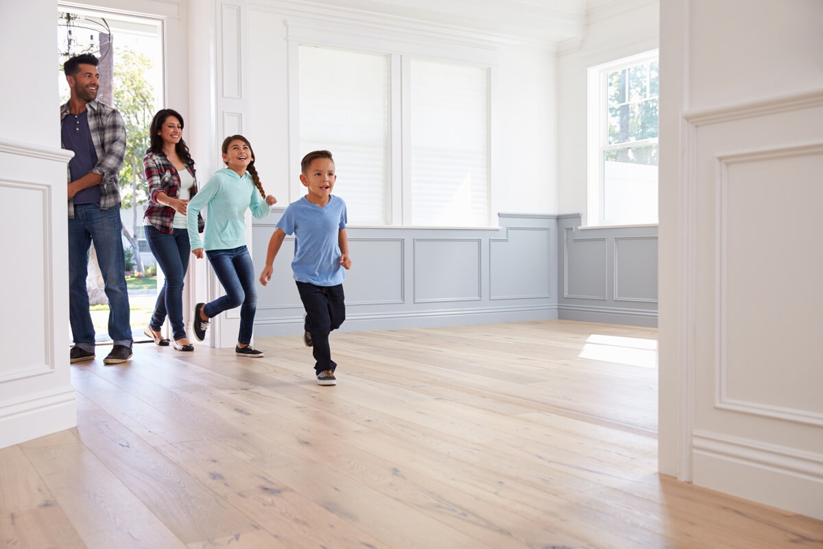 Family entering new empty home